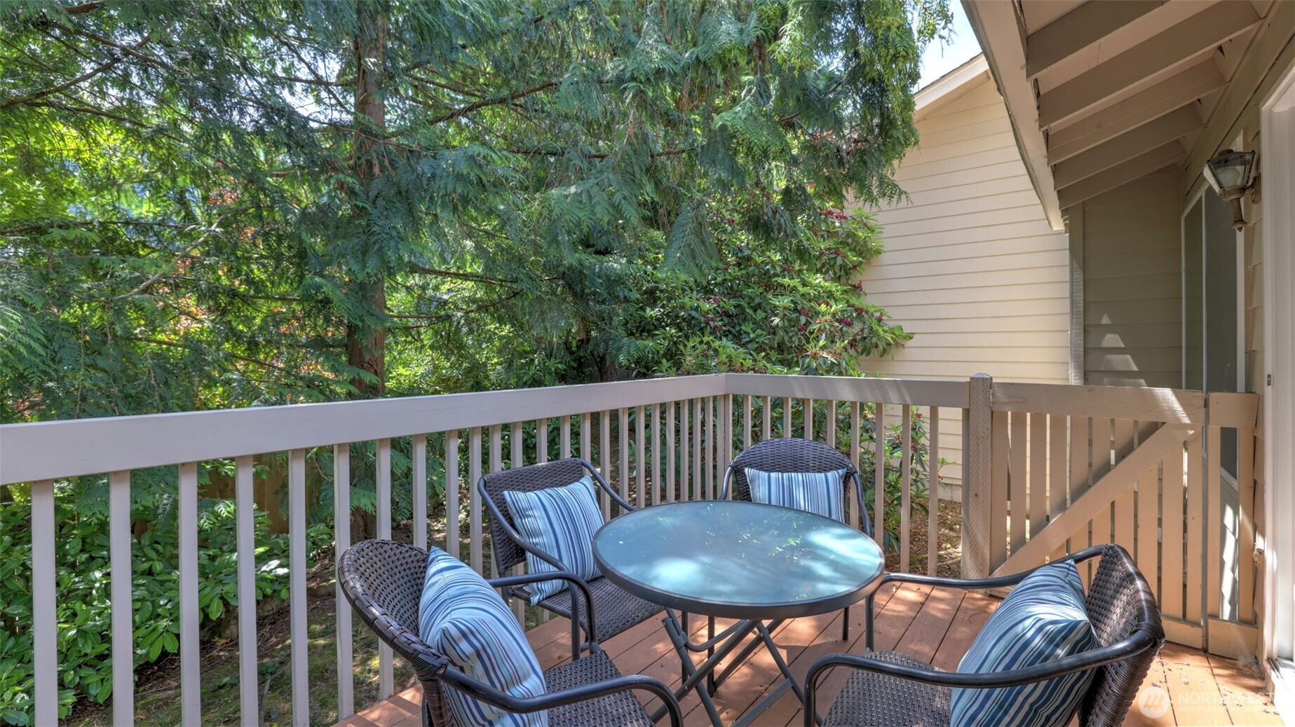 Just beyond the glass sliding door, a beautiful wooden deck awaits—perfect for adding your own seating, tables, and entertaining guests