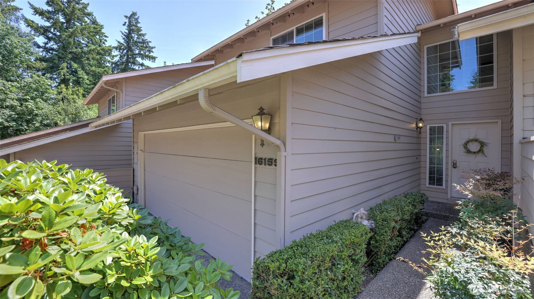 A generous two-car garage complements the home, with a long path leading to the inviting front entrance