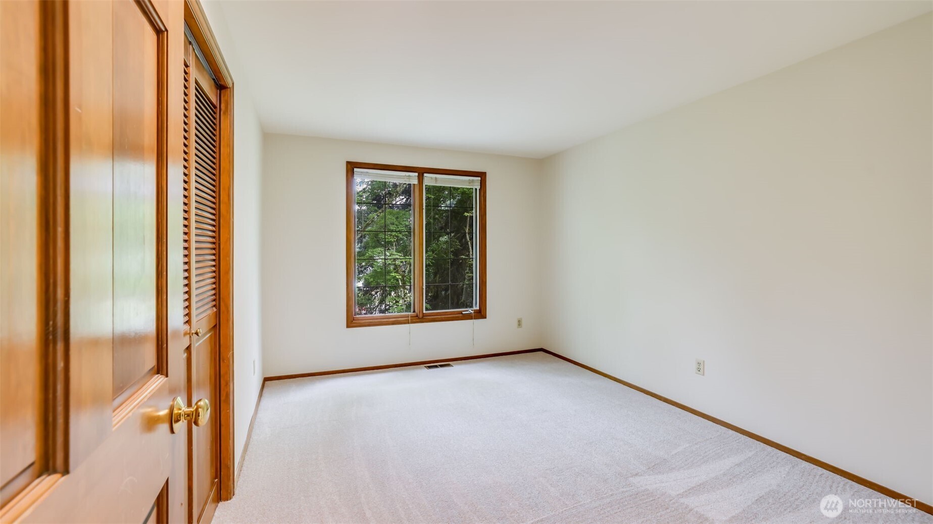 The 2nd bedroom after the Primary suite. The entire home has panel doors.