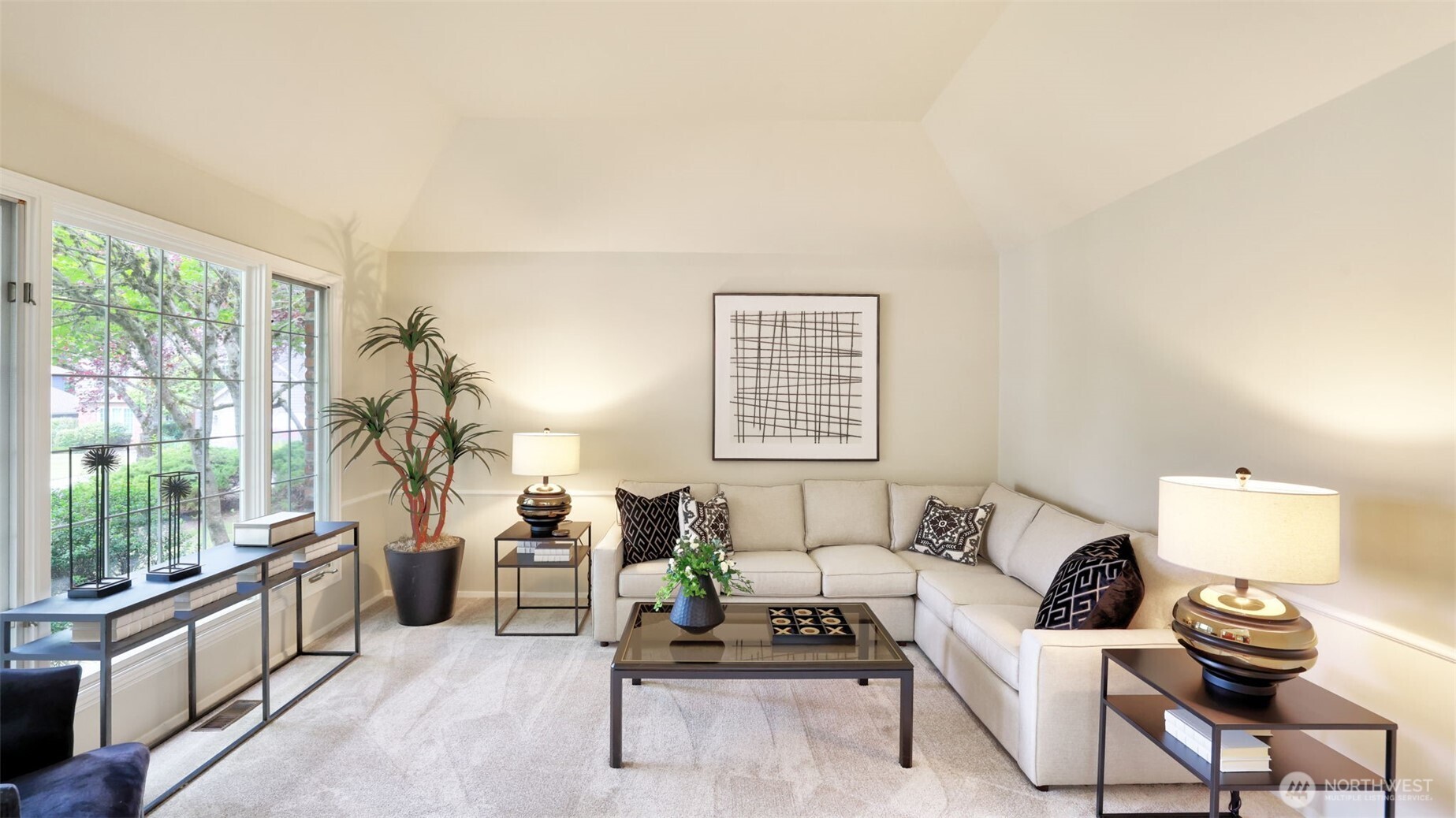 The living room has natural light that streams through the oversized window.