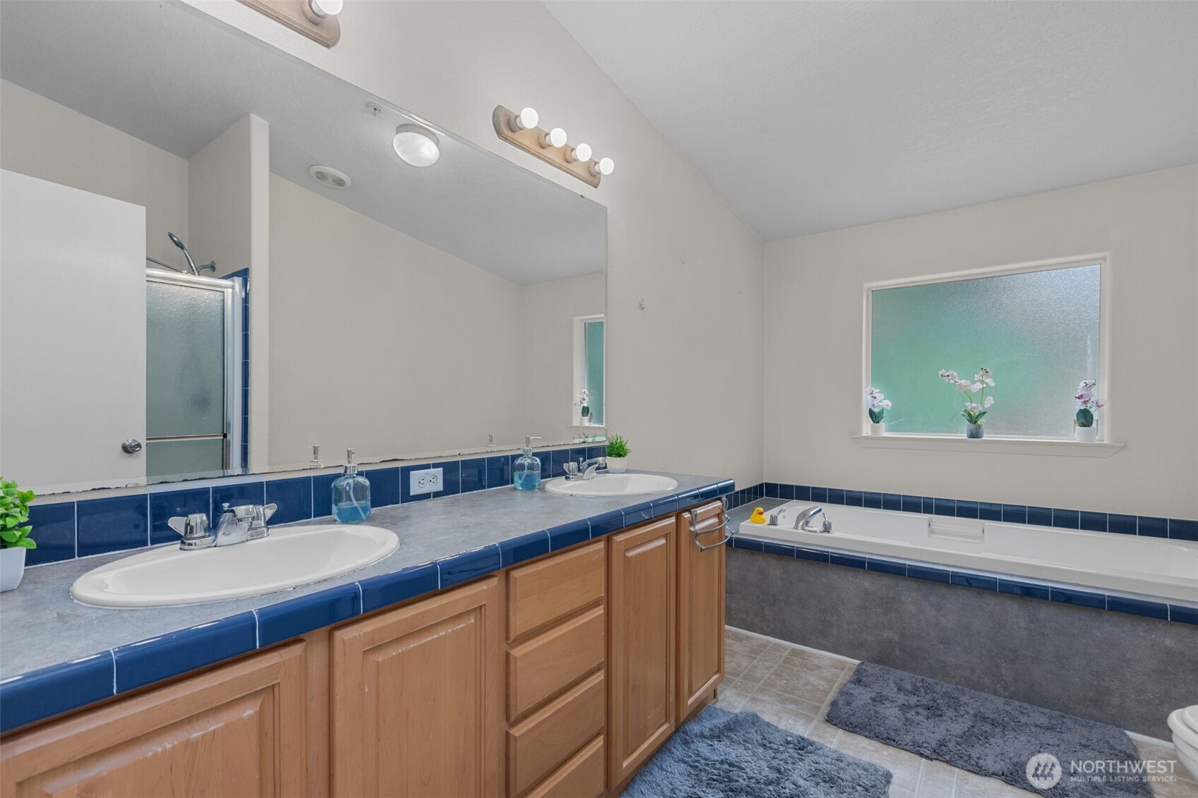 The primary bathroom features a large soaking tub and separate shower.