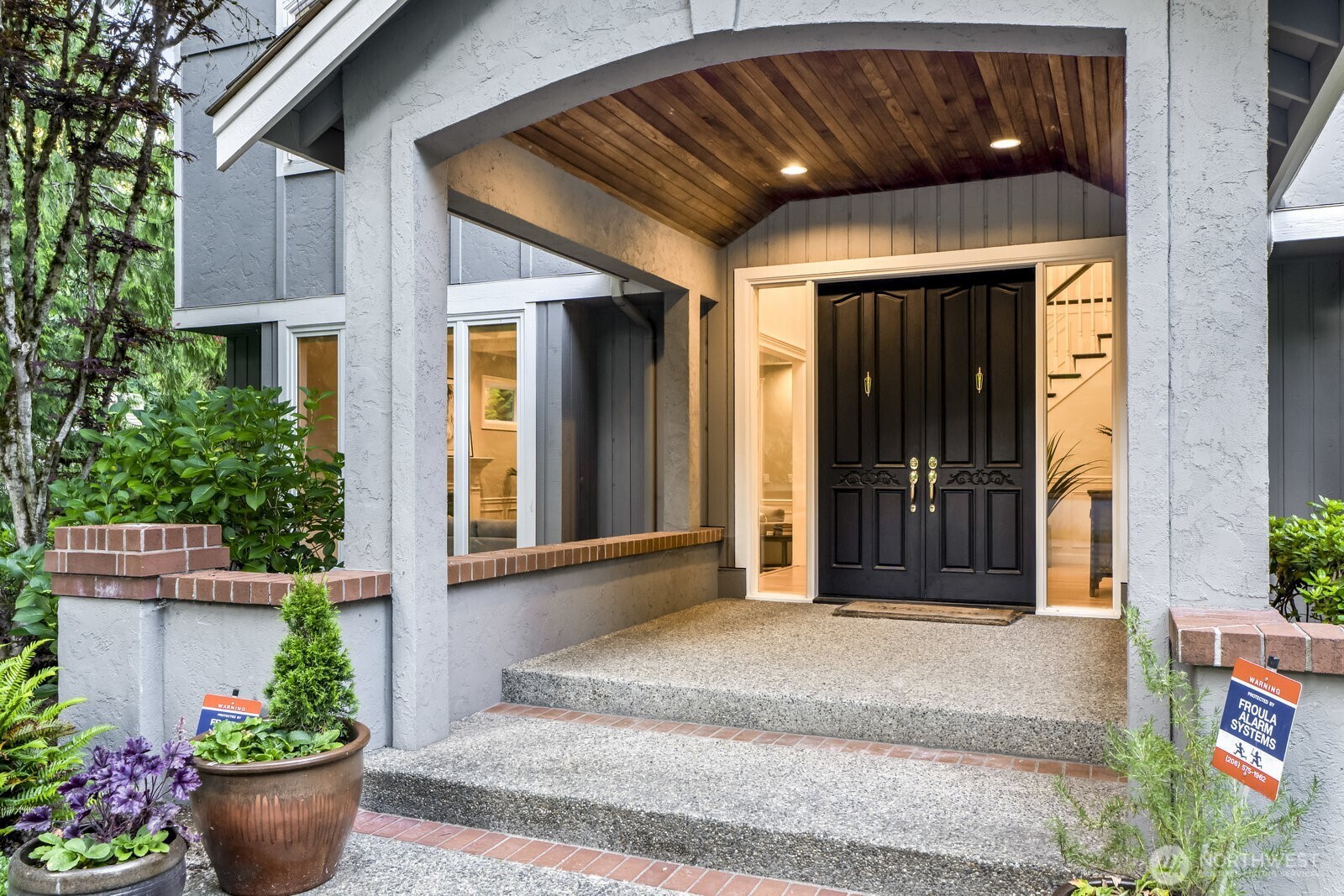 As you approach the cedar lined covered front entry double doors open into the voluminous foyer.