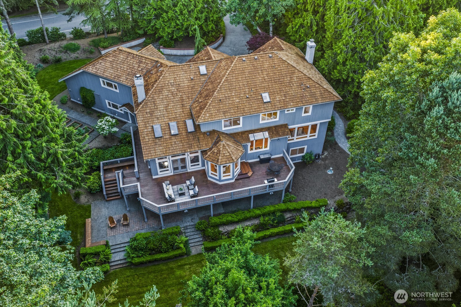 The 1.8 acre lot features extensive stonewalling, 3 dry riverbeds, gravel walk ways, 3 raised garden beds with irrigation, 120-V lighting, sprinklers, an electric outlet in the lower yard, invisible fencing and backs to greenbelt.