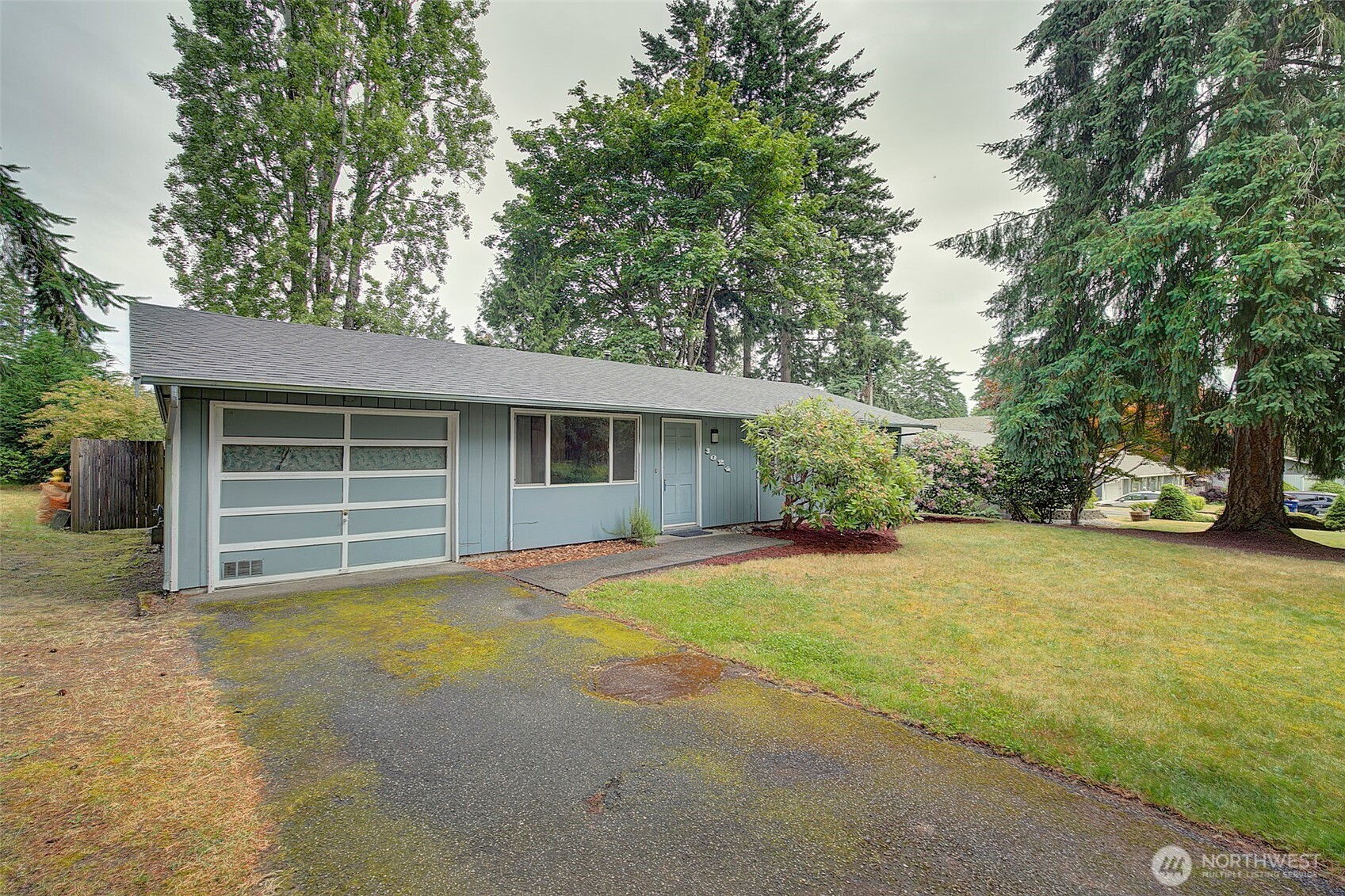 Spacious front yard with plenty of driveway parking and single car garage
