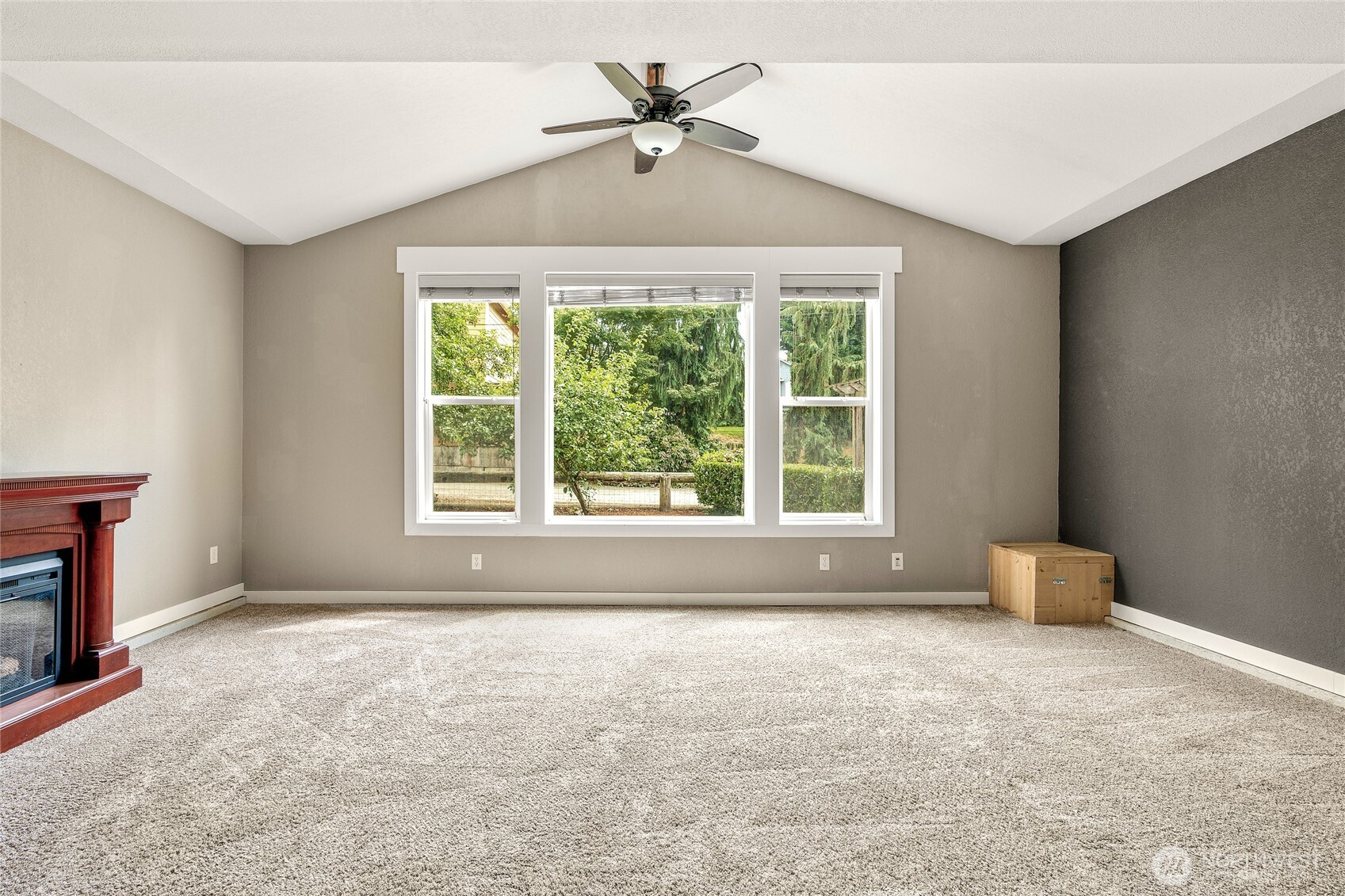 Living room features fan & vaulted ceiling