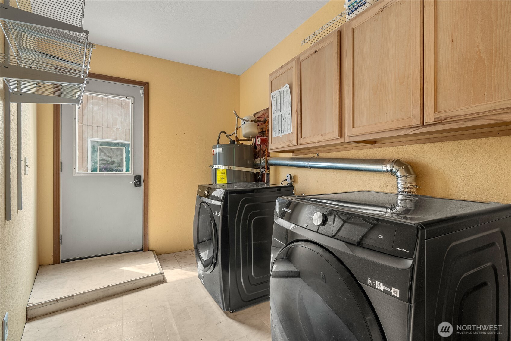 spacious utility room with side door access to detached garage