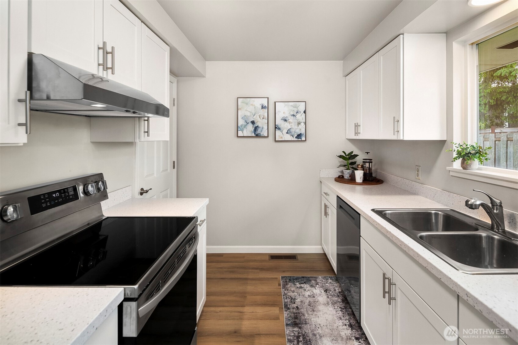 The upgraded kitchen, a chef's delight, boasts sleek quartz counters, new cabinets, and all-new appliances, plus direct garage access