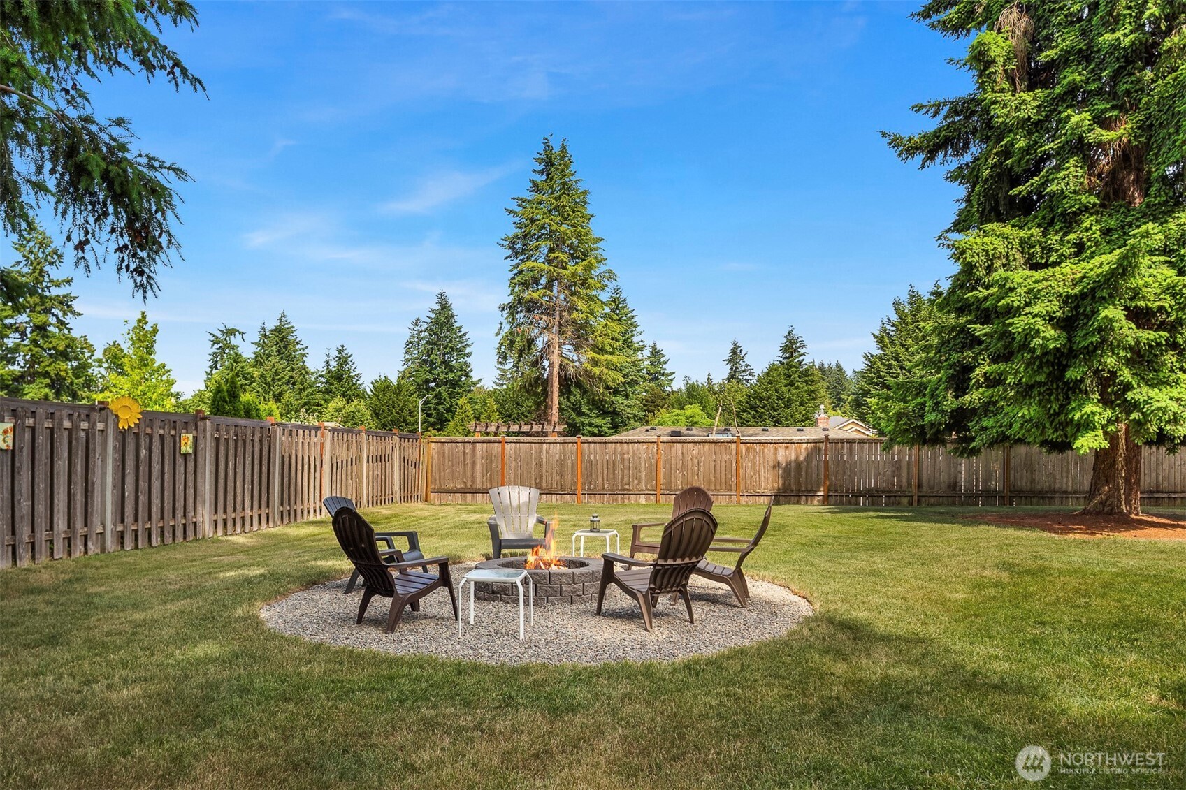 Step outside to a partially fenced, extra-large backyard with an inviting firepit—ample room to play, garden, or entertain