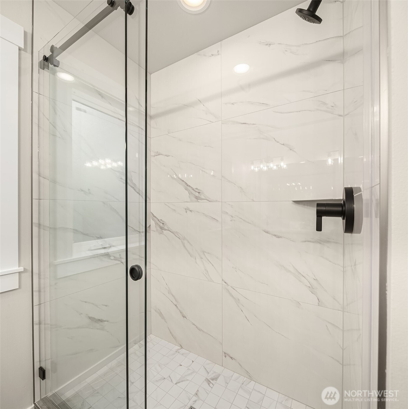 Stylishly appointed shower with upscale marble finishes