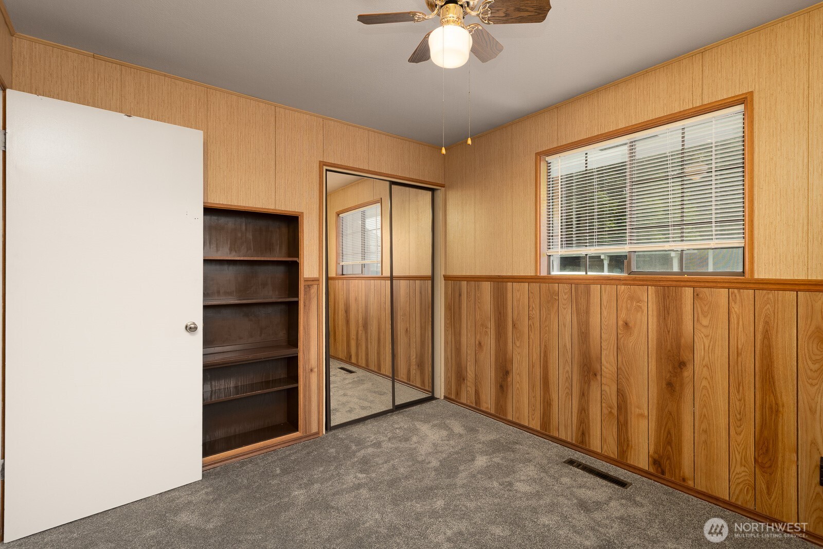 This bedroom features a built in book case/storage shelving unit. It's what ever you want it to be.