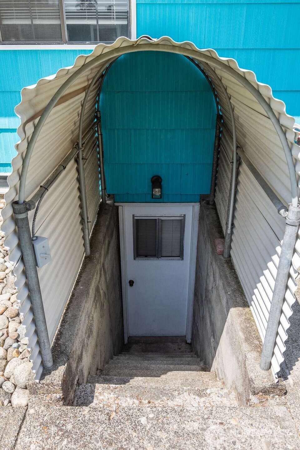 Nice, creative cover keeps the rain out and shelters the doorway from the weather.