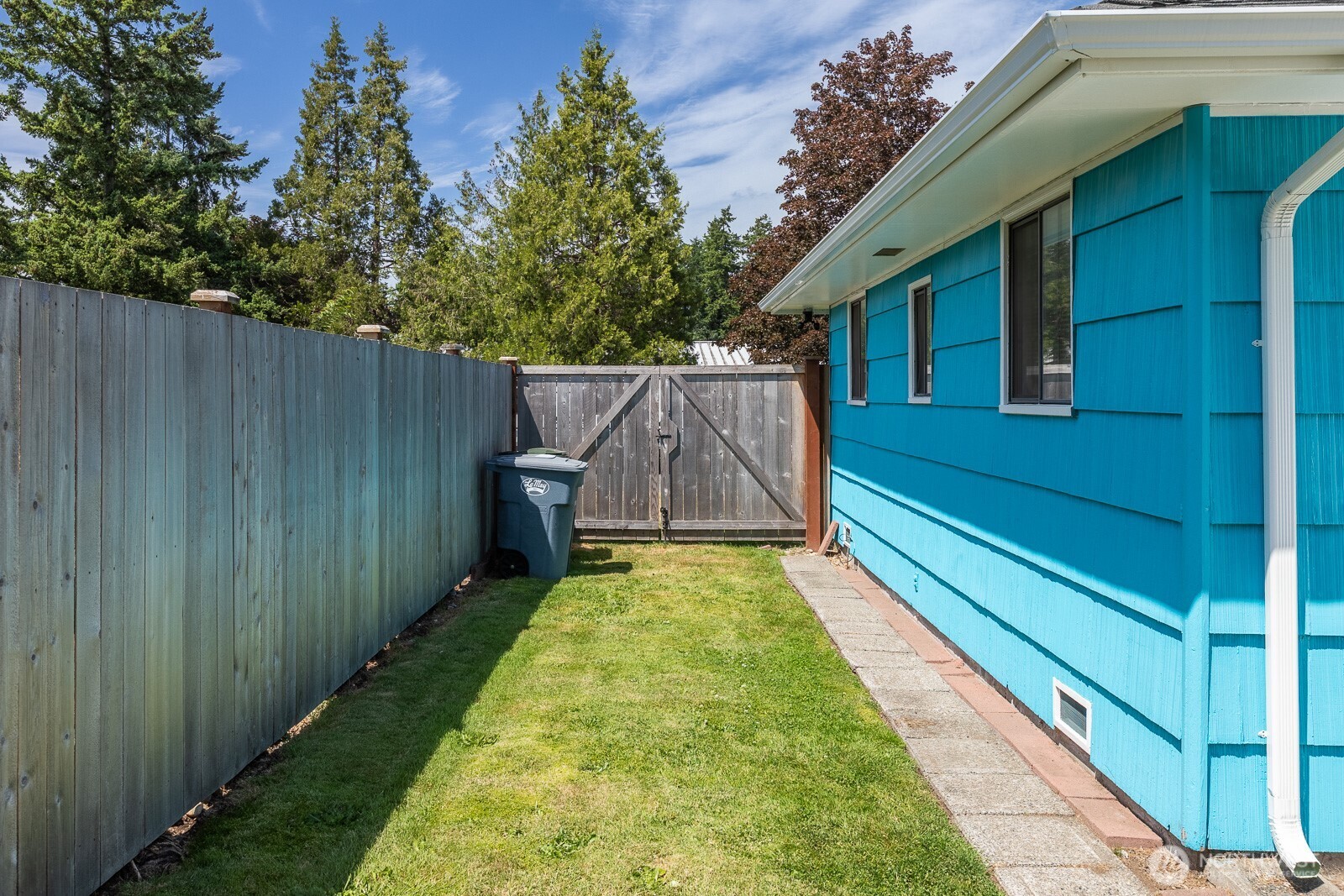 West side yard has gate and could store a small RV. Pavers are nice to have and note the nice clean gutters and soffits.