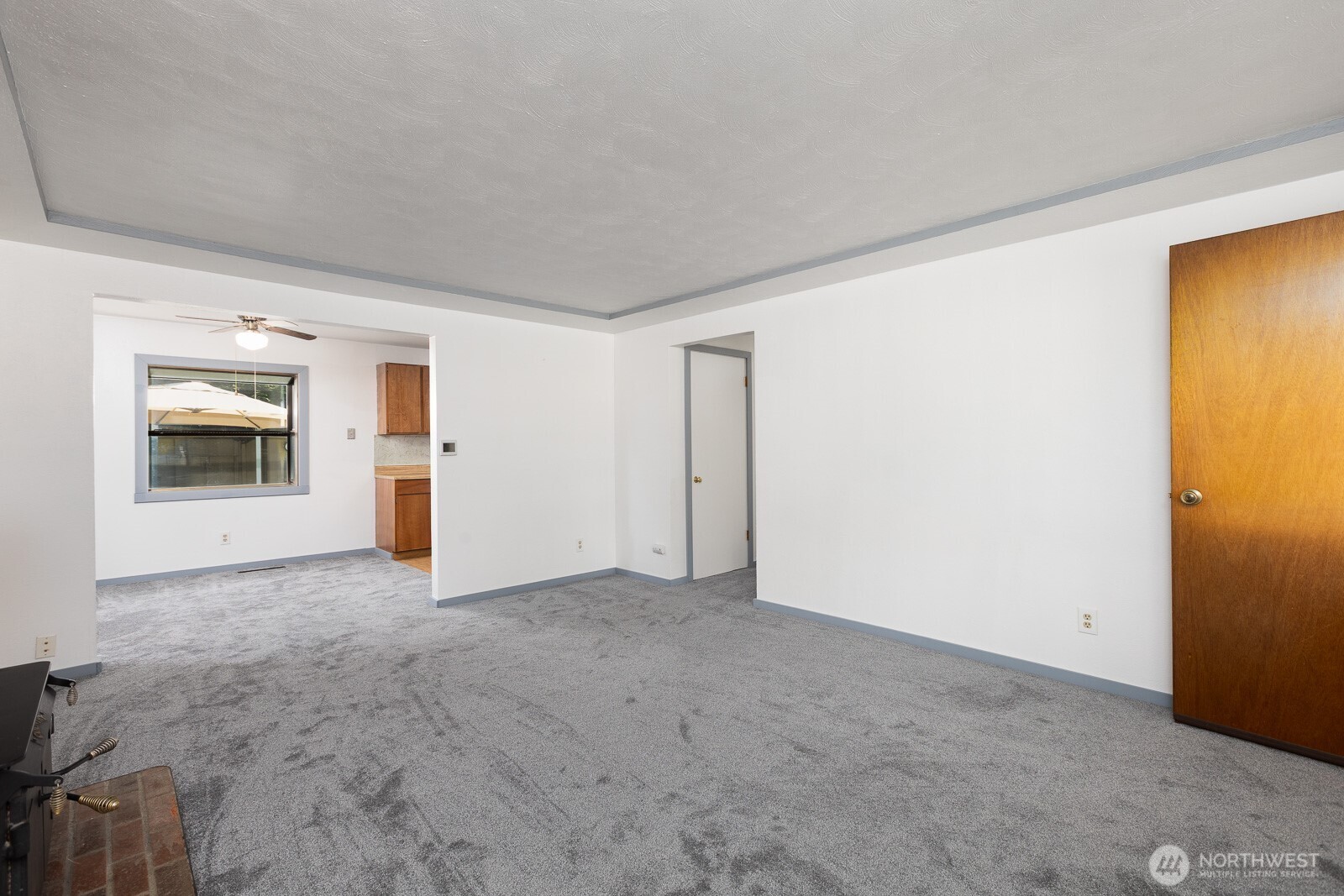 Large open living room and spacious opening to dining area. Home features a built in security system with pressure pads under the carpet in two areas to detect someone prior to entering the bedroom area.