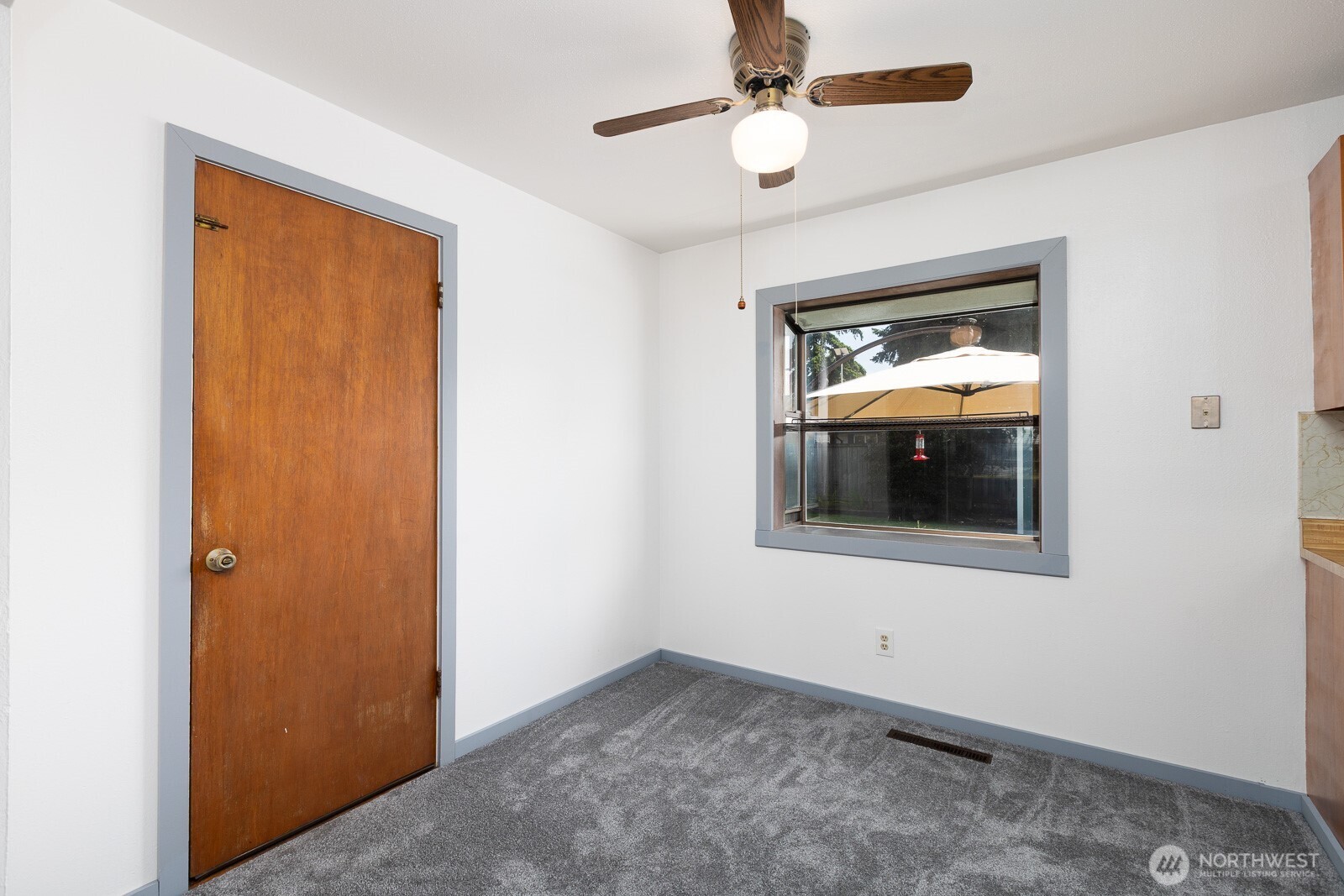 Dining room featuring a garden window, New carpet, trim and paint here. This door leads to the garage.