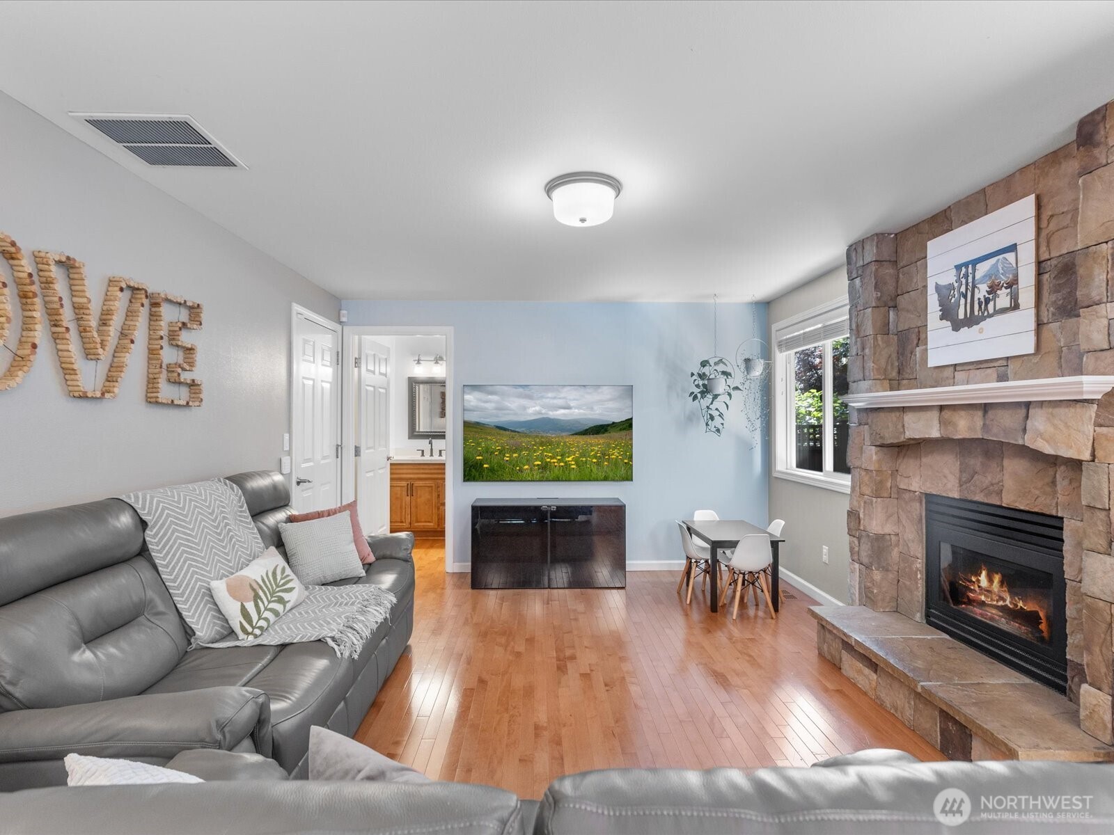 Open family room with custom stone gas fireplace