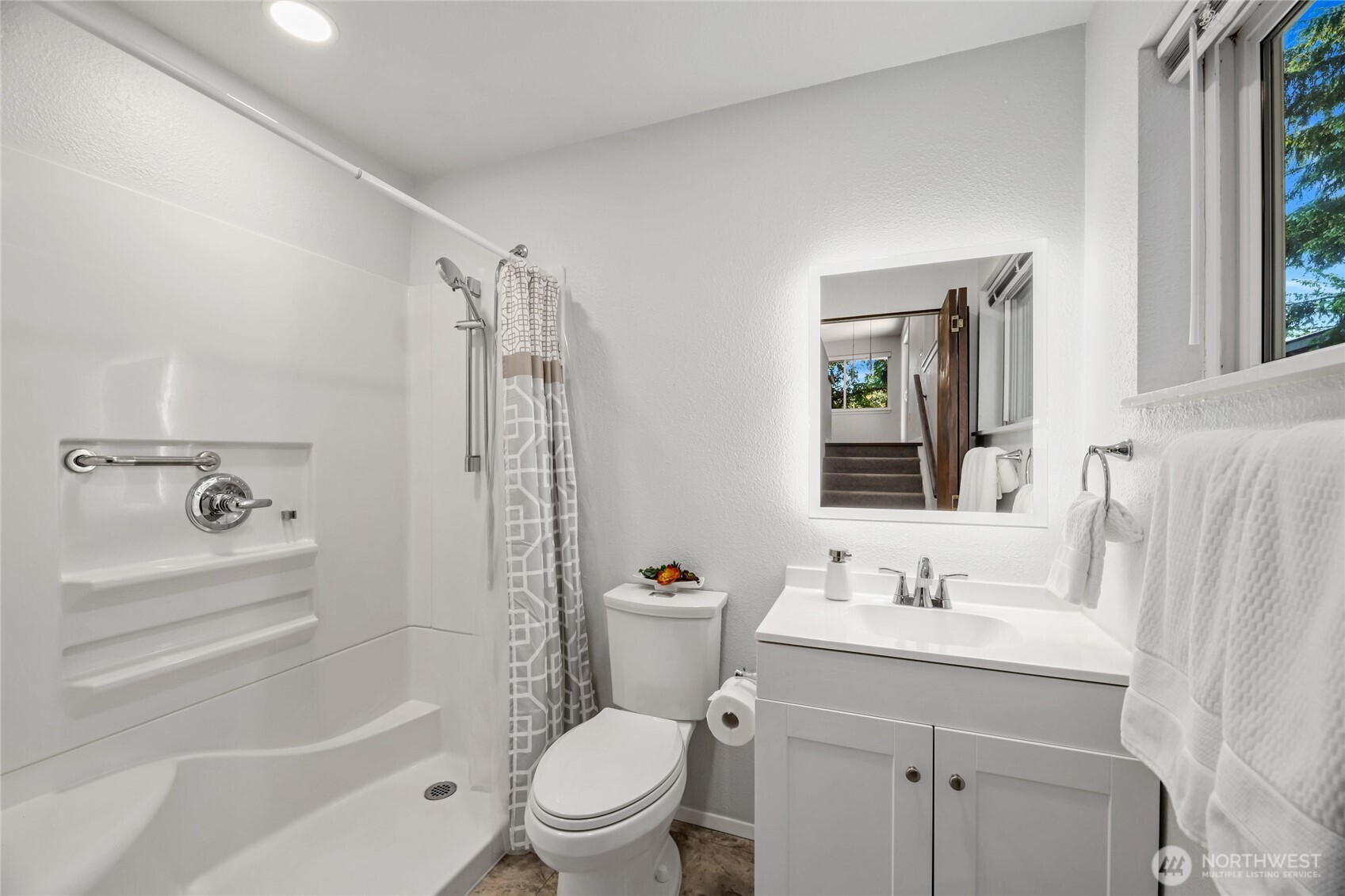 Updated Lower Bathroom is updated with walk-in shower, dimming lights, & adustable backlit LED mirror.