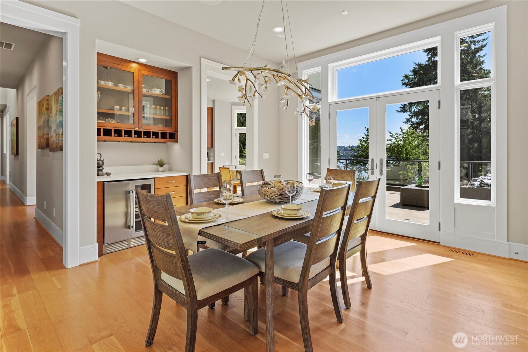 Formal dining room provides access to both the deck and a private patio, complete with a built-in buffet, wine/beverage cooler, and glass upper cabinetry