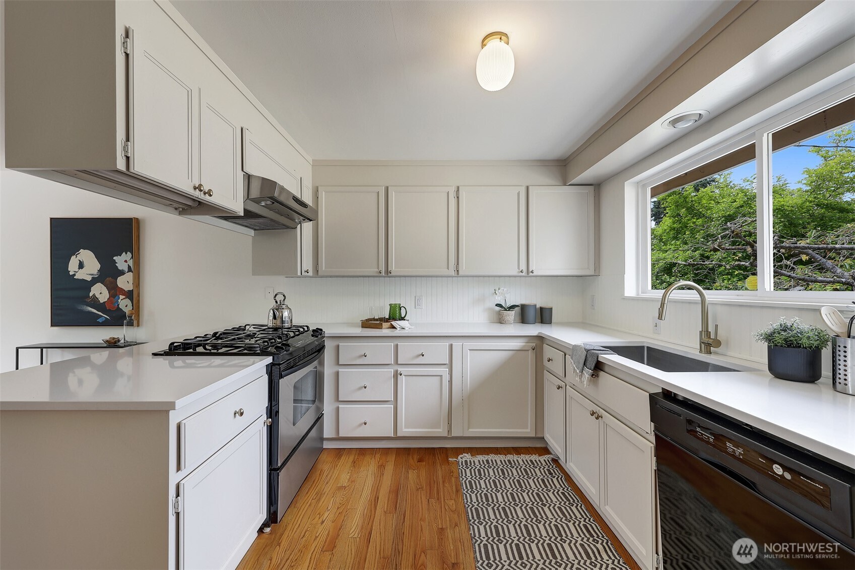 Whip up meals and memories in this light-filled kitchen—complete with quartz countertops, bar seating, and a seamless flow perfect for hosting and gathering