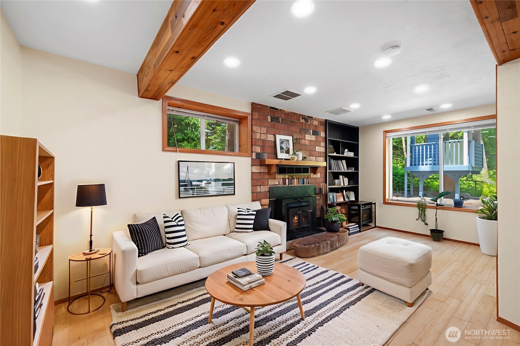 Cozy yet spacious with exposed beams and brick fireplace, this lower-level family room invites movie nights, reading nooks, and conversation. Virtual staging highlights just how livable and inviting it can be.