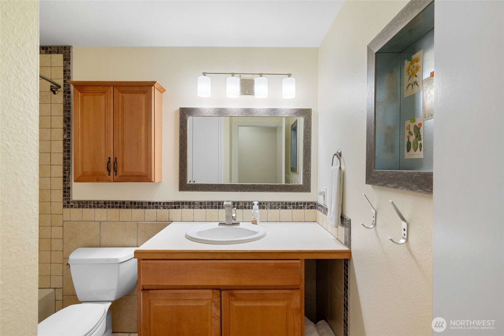 Lower-Level Full Bath A well-maintained second full bath with classic tilework, wood cabinetry, and ample storage—perfect for guests or multigenerational living.