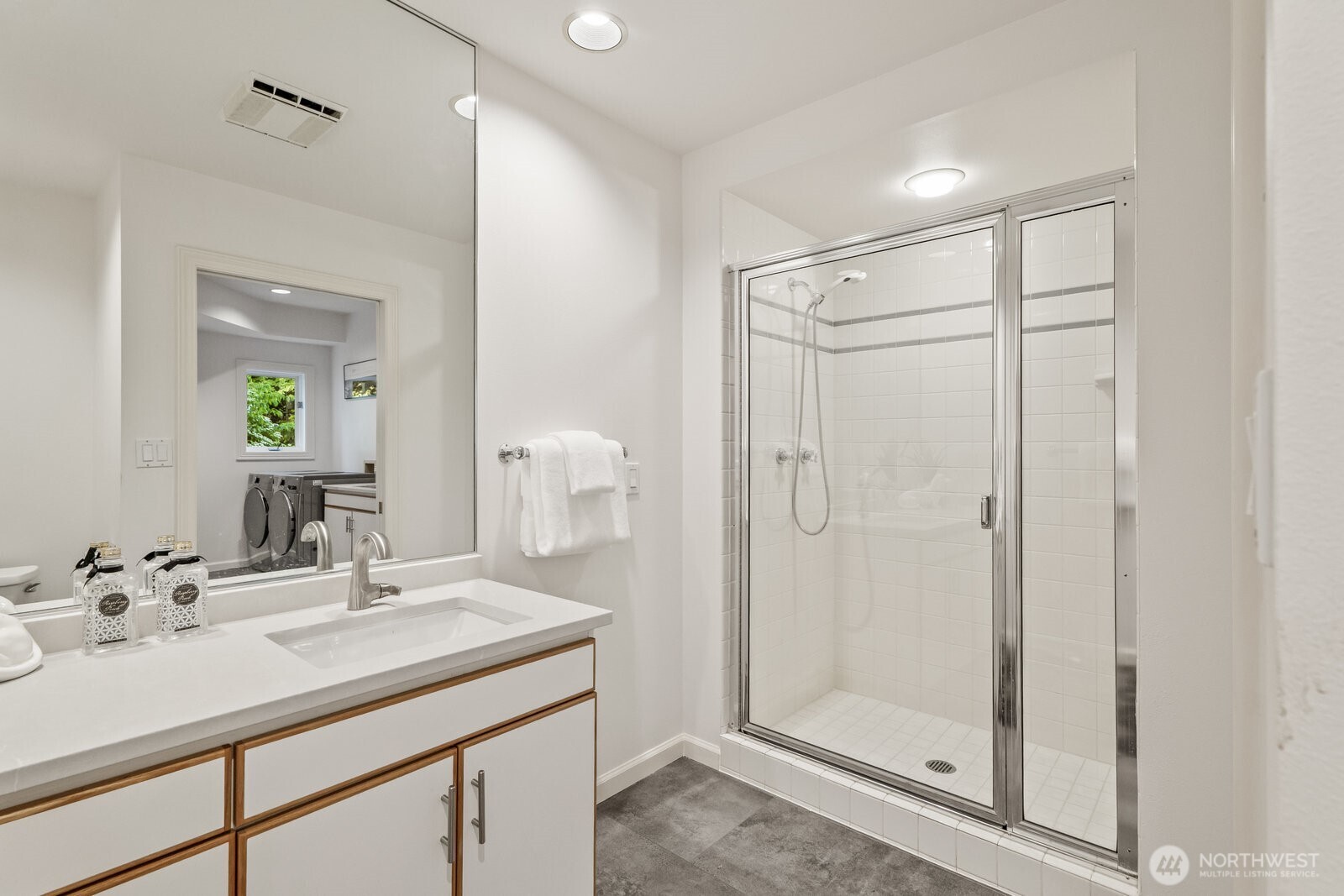 3/4 bathroom with a quartz vanity conveniently located for those who like to work in the yard, kids rolling in the mud or soiled dogs that need hosing off.