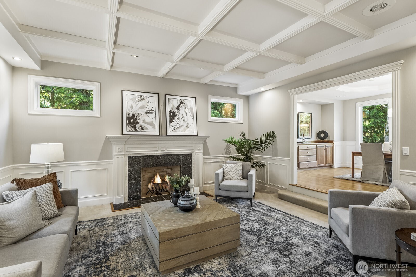 The formal rooms off to the left feature a marble surround wood burning fireplace, wainscoting and tall tray ceiling.