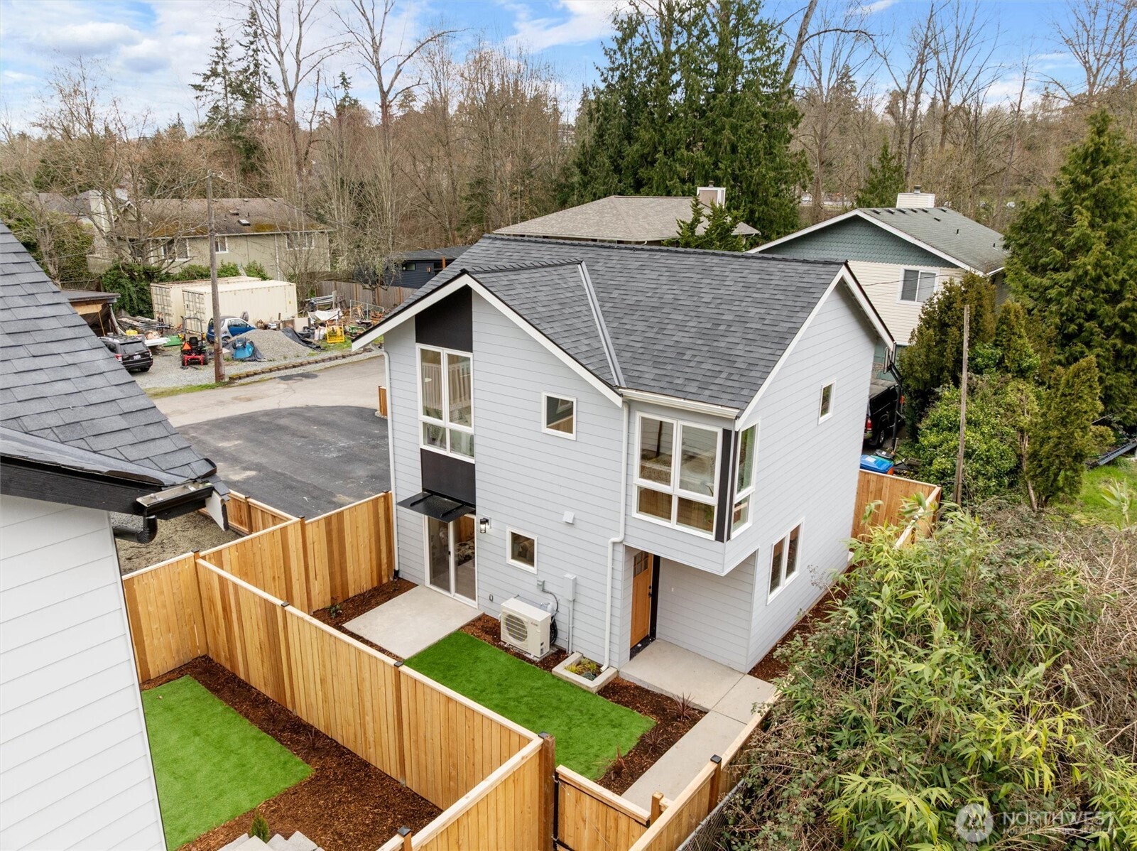 Modern design meets privacy in this thoughtfully fenced two-story home with low-maintenance landscaping.