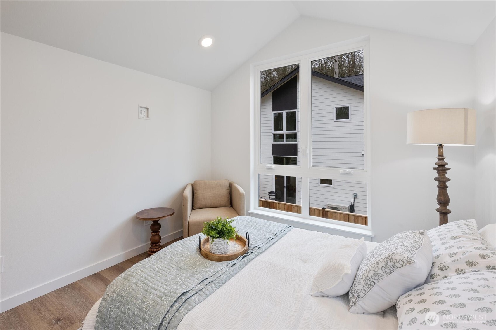 Vaulted ceilings and designer finishes enhance the airy ambiance of this charming bedroom retreat.
