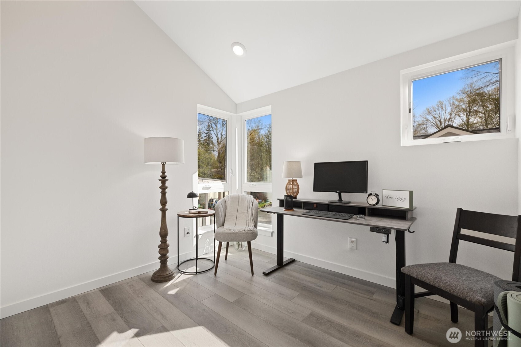 This bright flex space with vaulted ceilings and corner windows is perfect for a home office or creative studio.