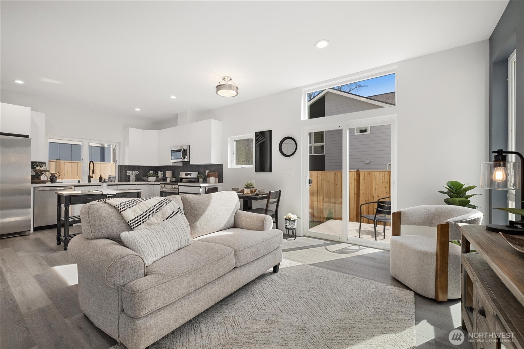 The seamless flow from the stylish kitchen to the sunlit living area creates an inviting and functional space for daily living.