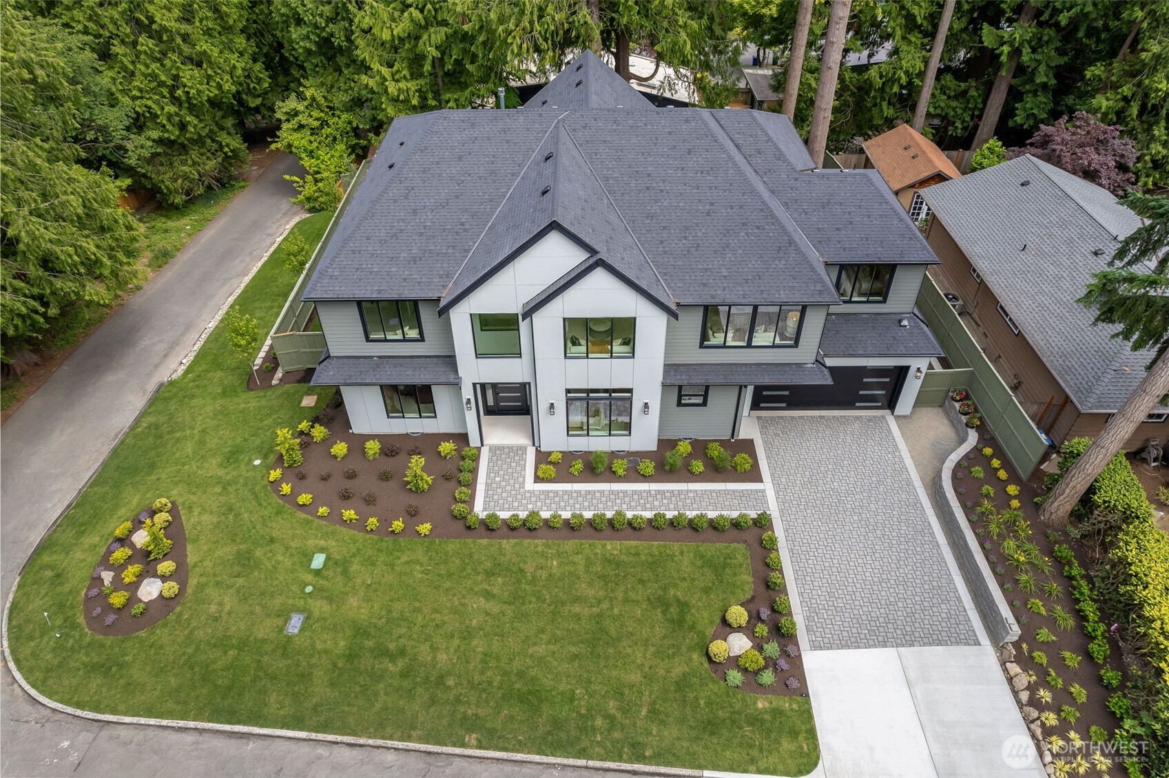 The house perched on a quiet, elevated corner lot surrounded by lush greenery