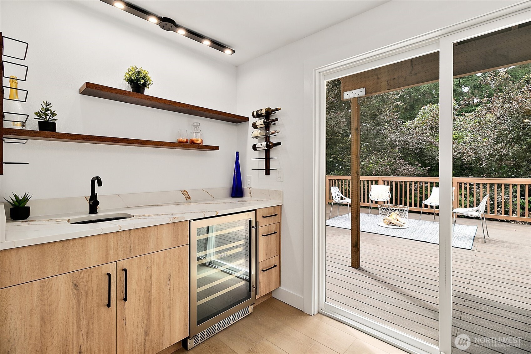 Wet bar at family room downstairs with Wine Cooler and luxurious decor