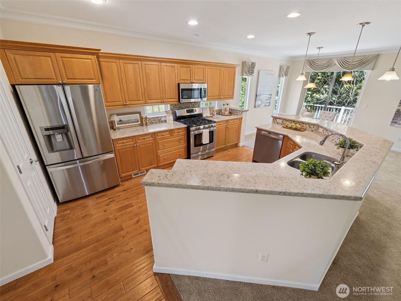 Chef's kitchen features side by side fridge, an abundance of cabinets and plenty of counter space for you and your company!