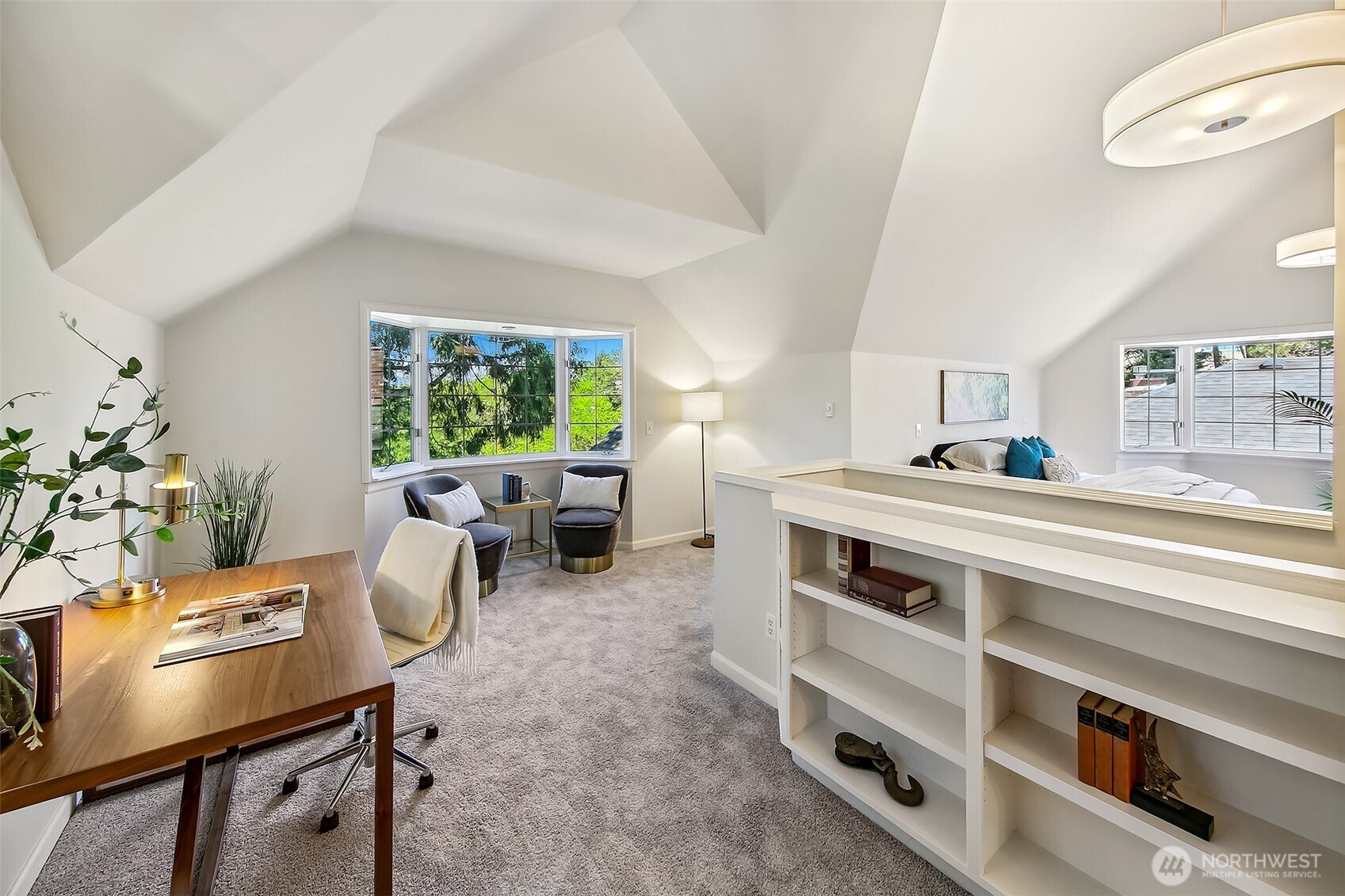 Expansive primary suite bathed in natural light, with vaulted ceilings, built-in shelving, and serene garden views for ultimate relaxation.