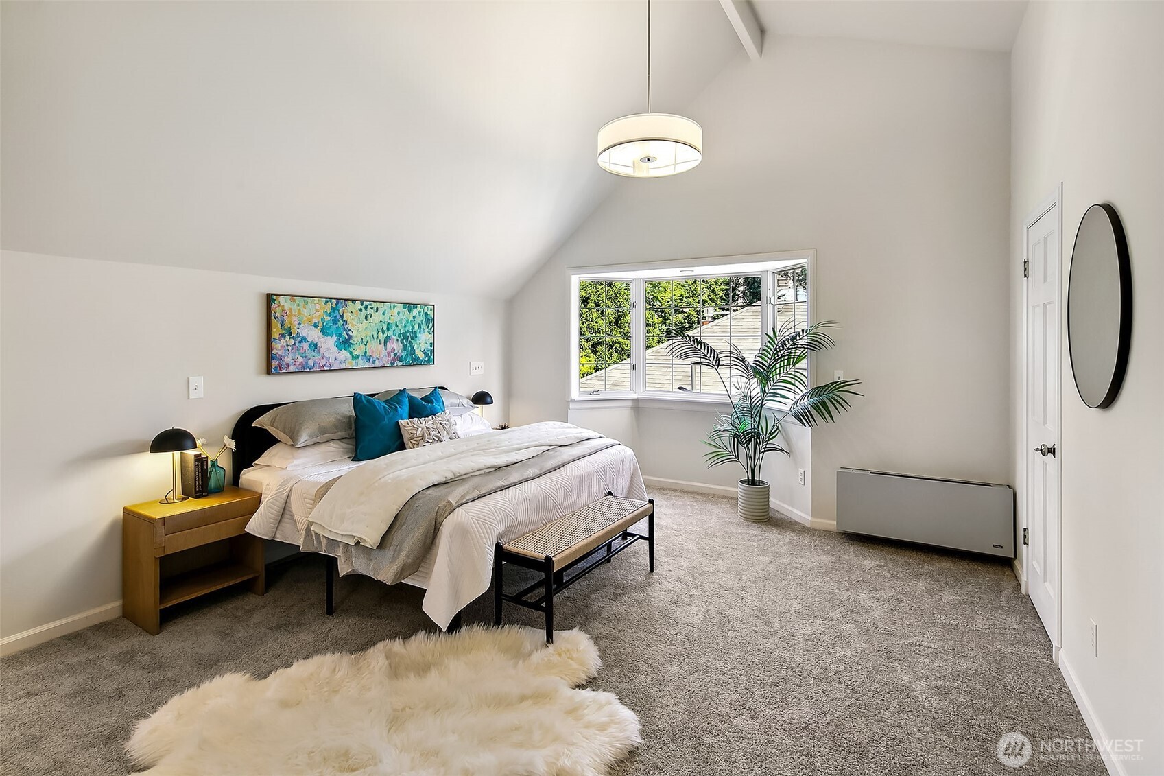 Bright secondary bedroom with vaulted ceiling and peaceful garden vistas—offering comfort and flexibility for guests or family.