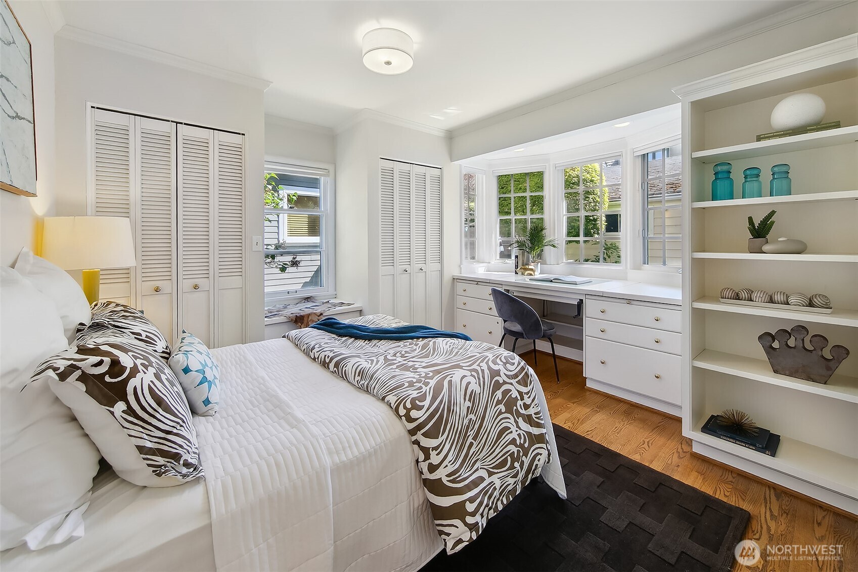 Main-level bedroom complete with built-in shelving and art-studio fittings, overlooking a tranquil garden with a gurgling fountain for peaceful, restful nights.