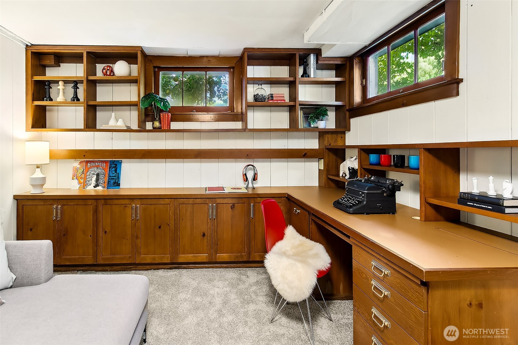 Handsome basement workshop/office with custom walnut cabinetry, ample built-in shelving and workbench—ready for creative projects or home-office pursuits.