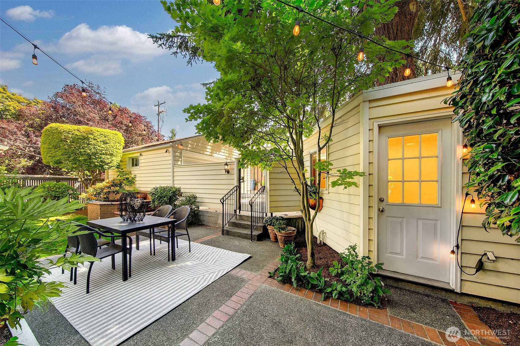 Evening light filters through mature maples onto the outdoor living terrace and finished annex—offering a serene extension of the home’s creative and social spaces.