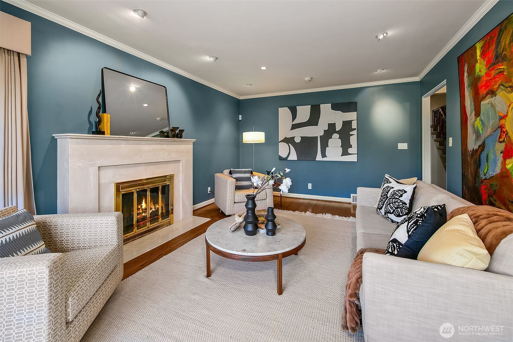 Secondary seating area within the gracious living room, warmed by a second fireplace and ideal for intimate gatherings.