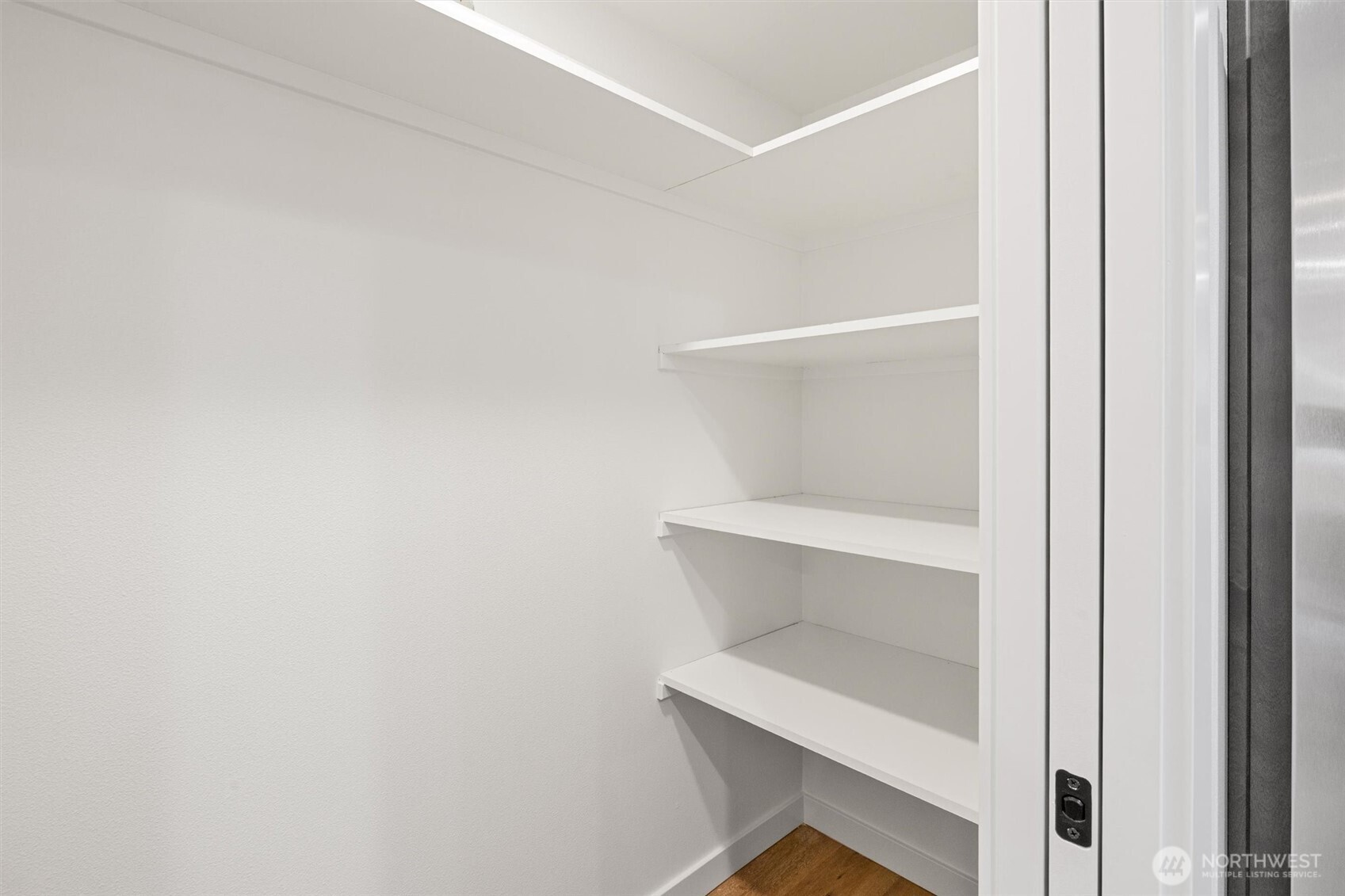 Spacious walk-in pantry provides ample storage with built-in shelving to keep everything organized and accessible.