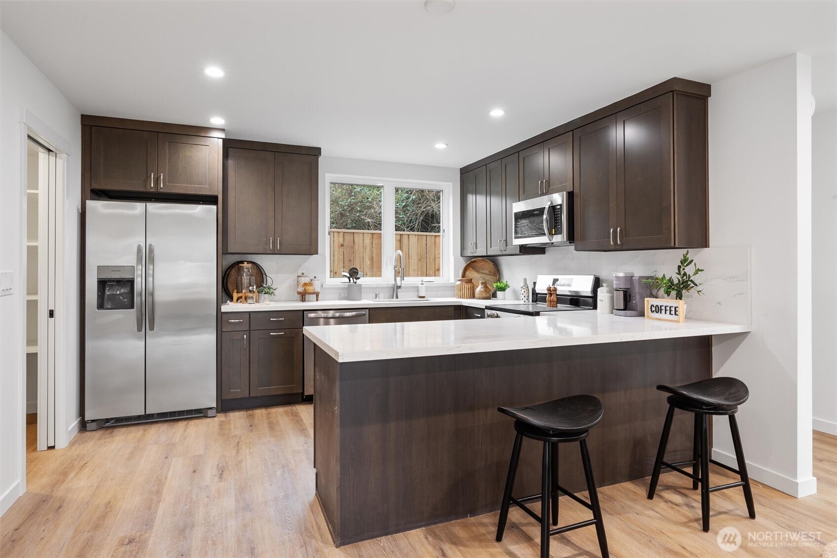 This chef-inspired kitchen features quartz countertops, stainless steel appliances, and full-height cabinetry.