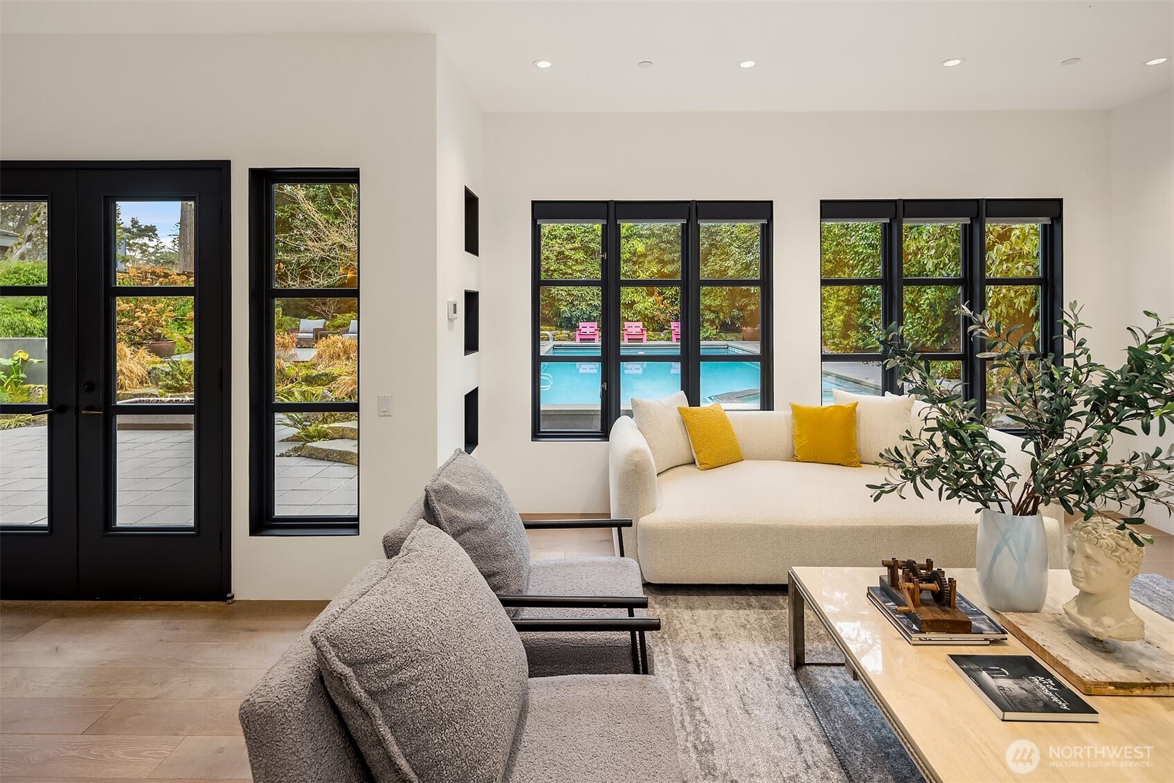 Windows overlook the pool and backyard.