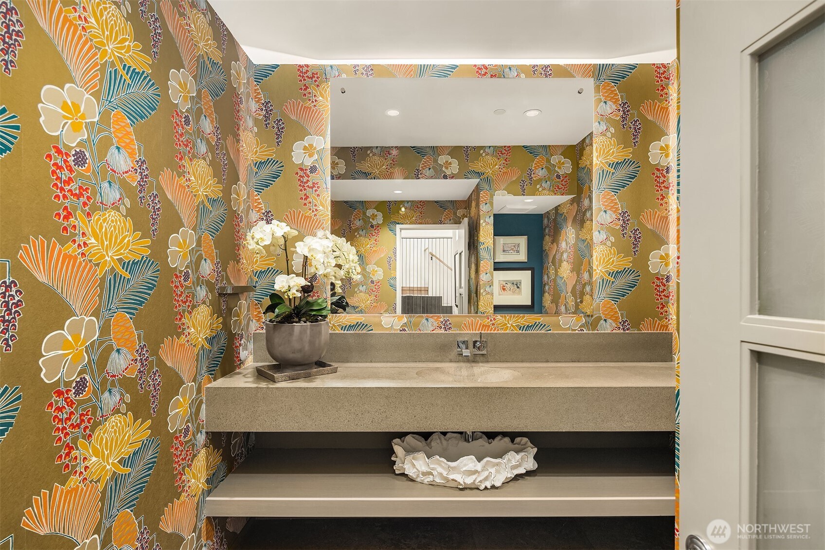 Main floor powder bathroom. We love the wallpaper and architectural desgined vanity.