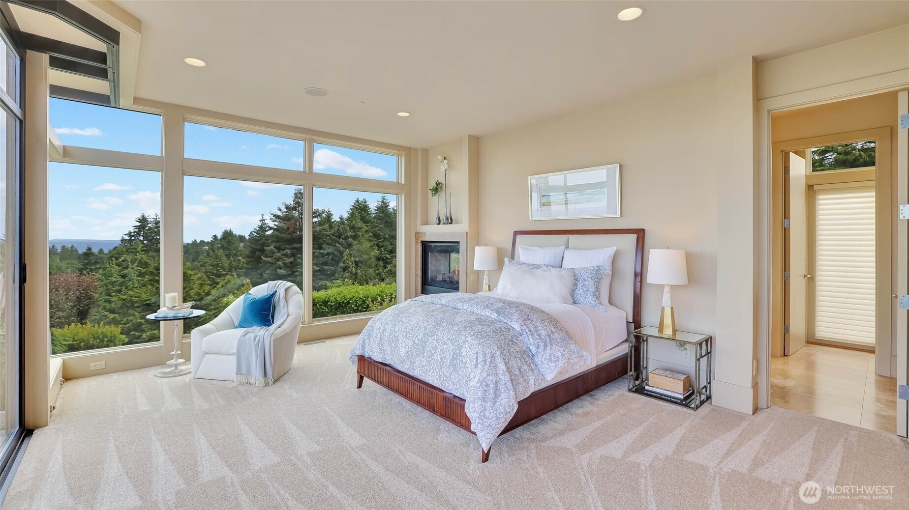 Retreat to the lavish main-floor primary suite, where spa-inspired luxury awaits. The bedroom with sitting area and cozy 2-sided gas fireplace invite you to relax and enjoy a good book.