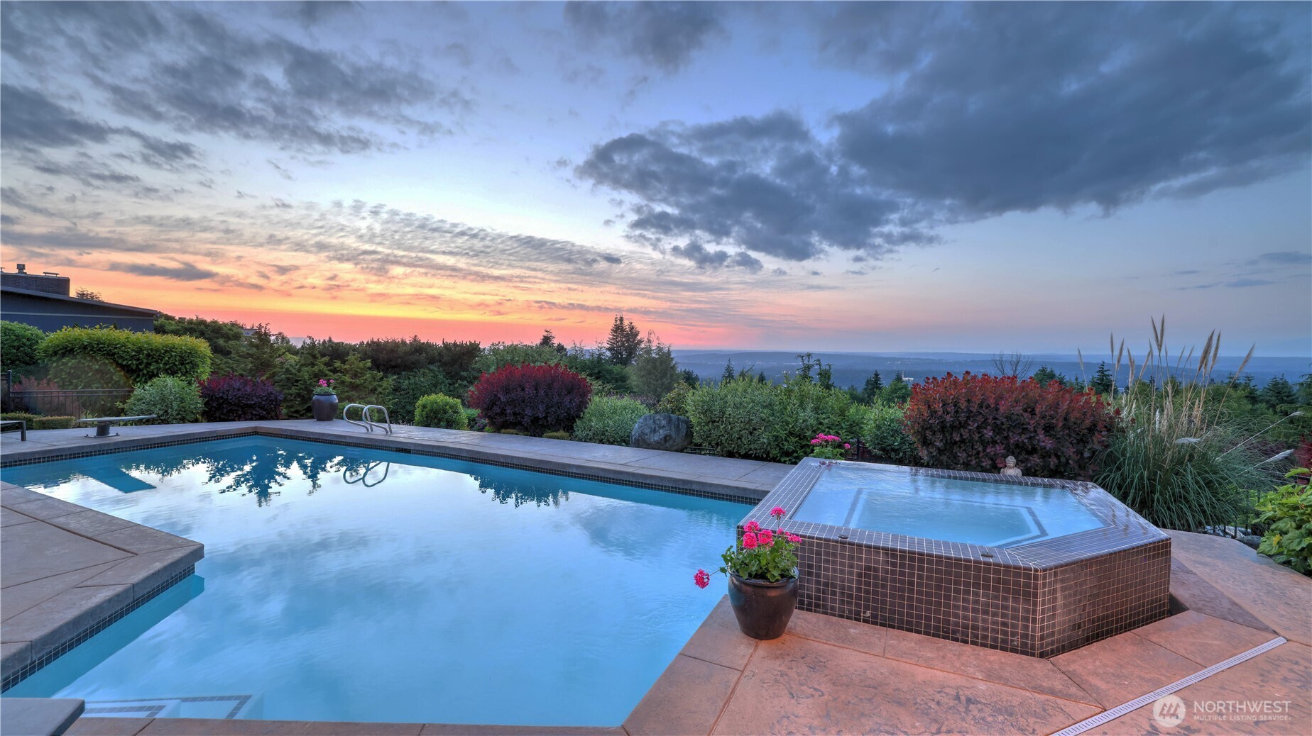 Front and rear yards are professionally landscaped with lush trees, native foliage and colorful annuals. There is a wrought iron fence around the perimeter of the pool deck.