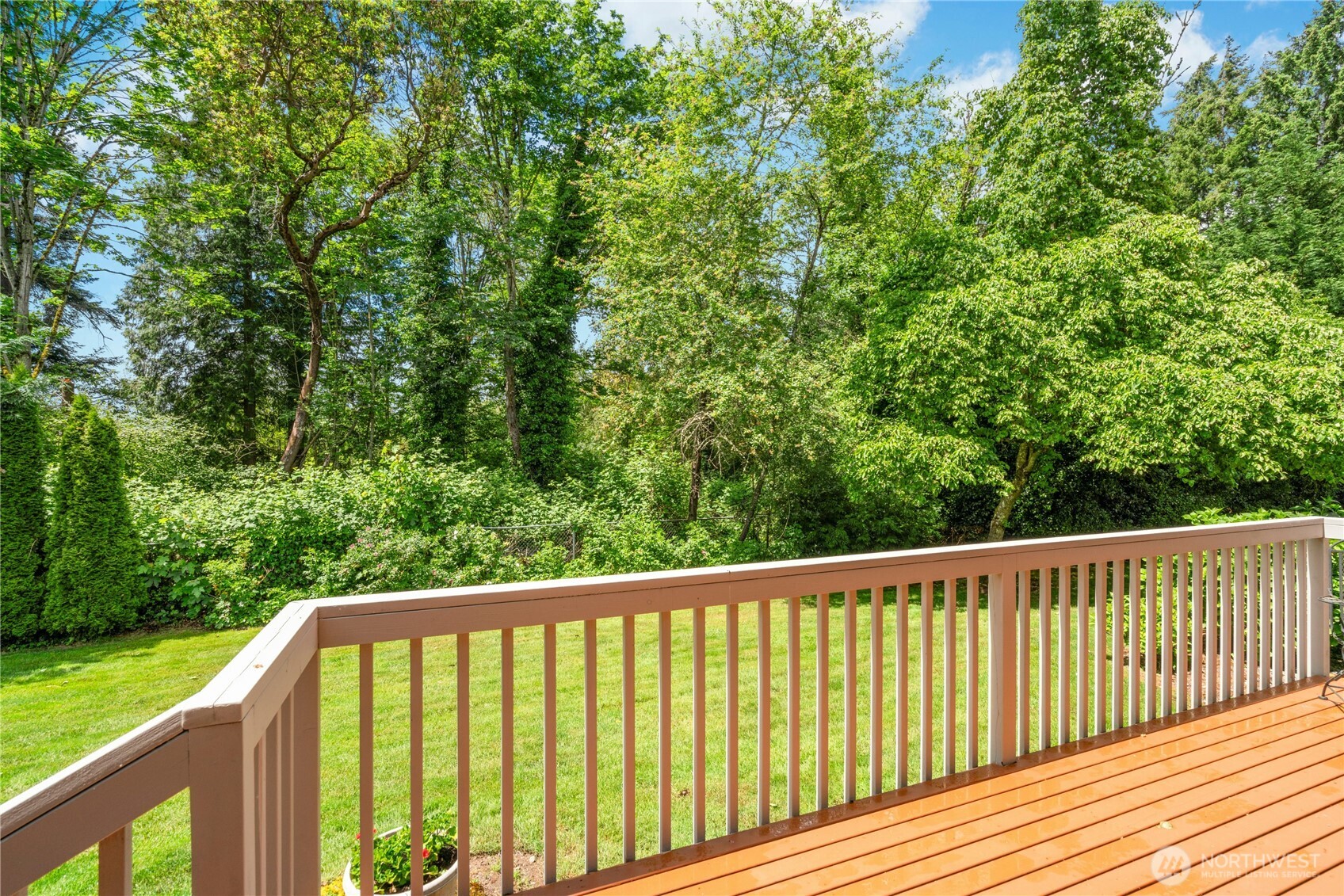 Serene views of greenbelt, flowering bushes & trees.