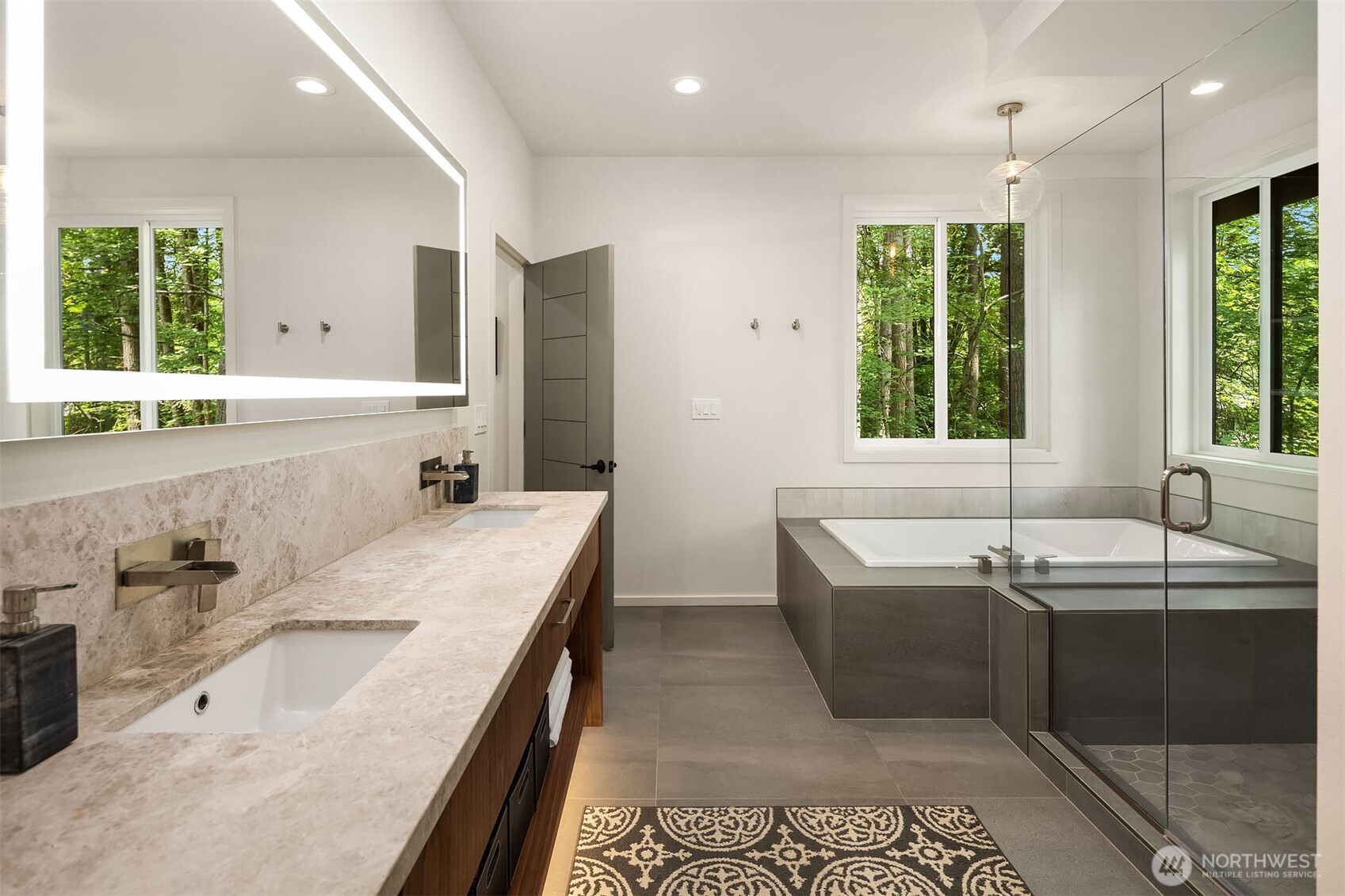 The primary bath is truly luxurious with a dual sink vanity, under cabinet lighting, lighted mirror, large soaking tub and separate shower.