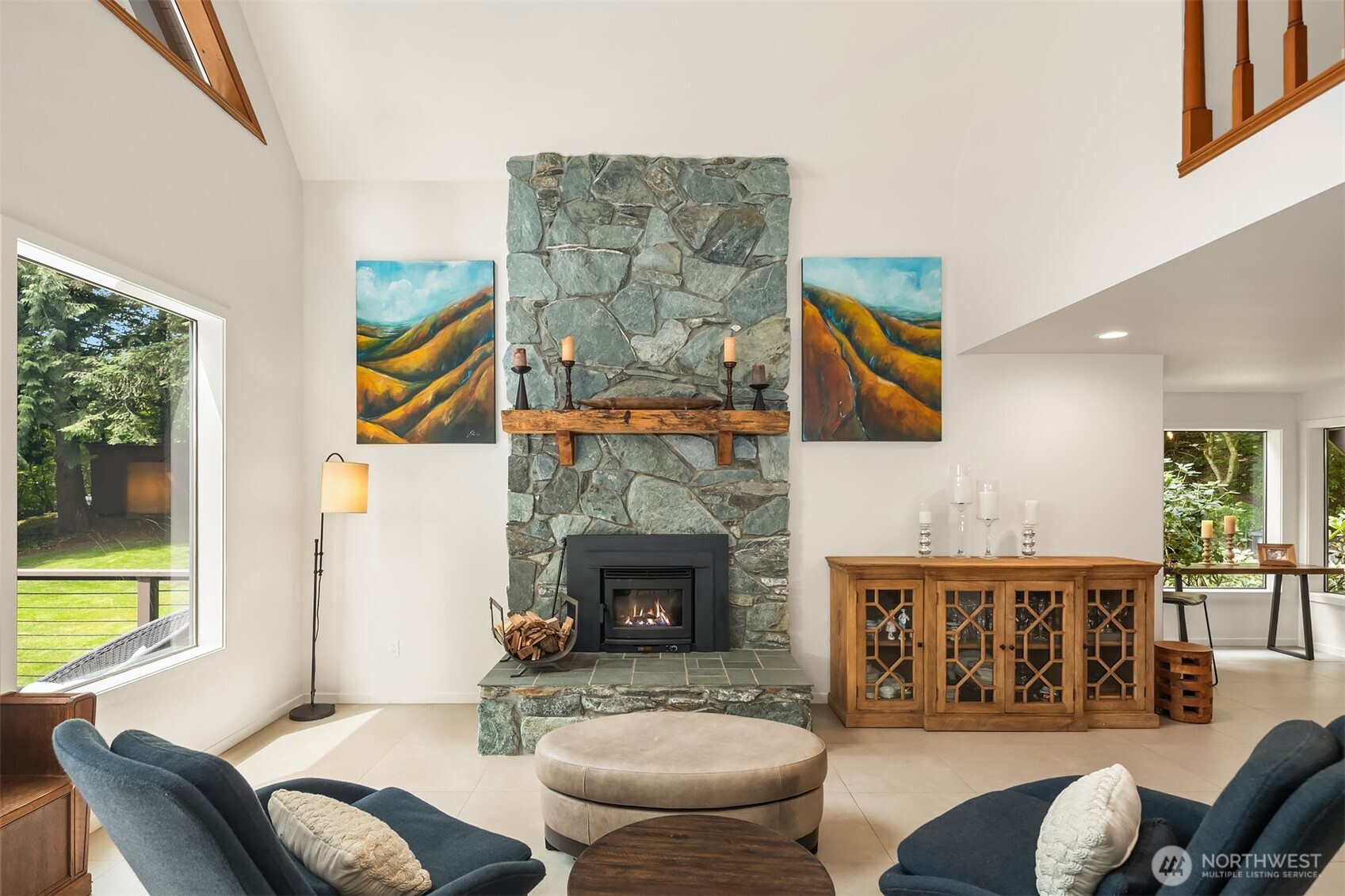 A stone surround fireplace with a new wood-burning insert in the great room creates an inviting ambiance for gatherings.