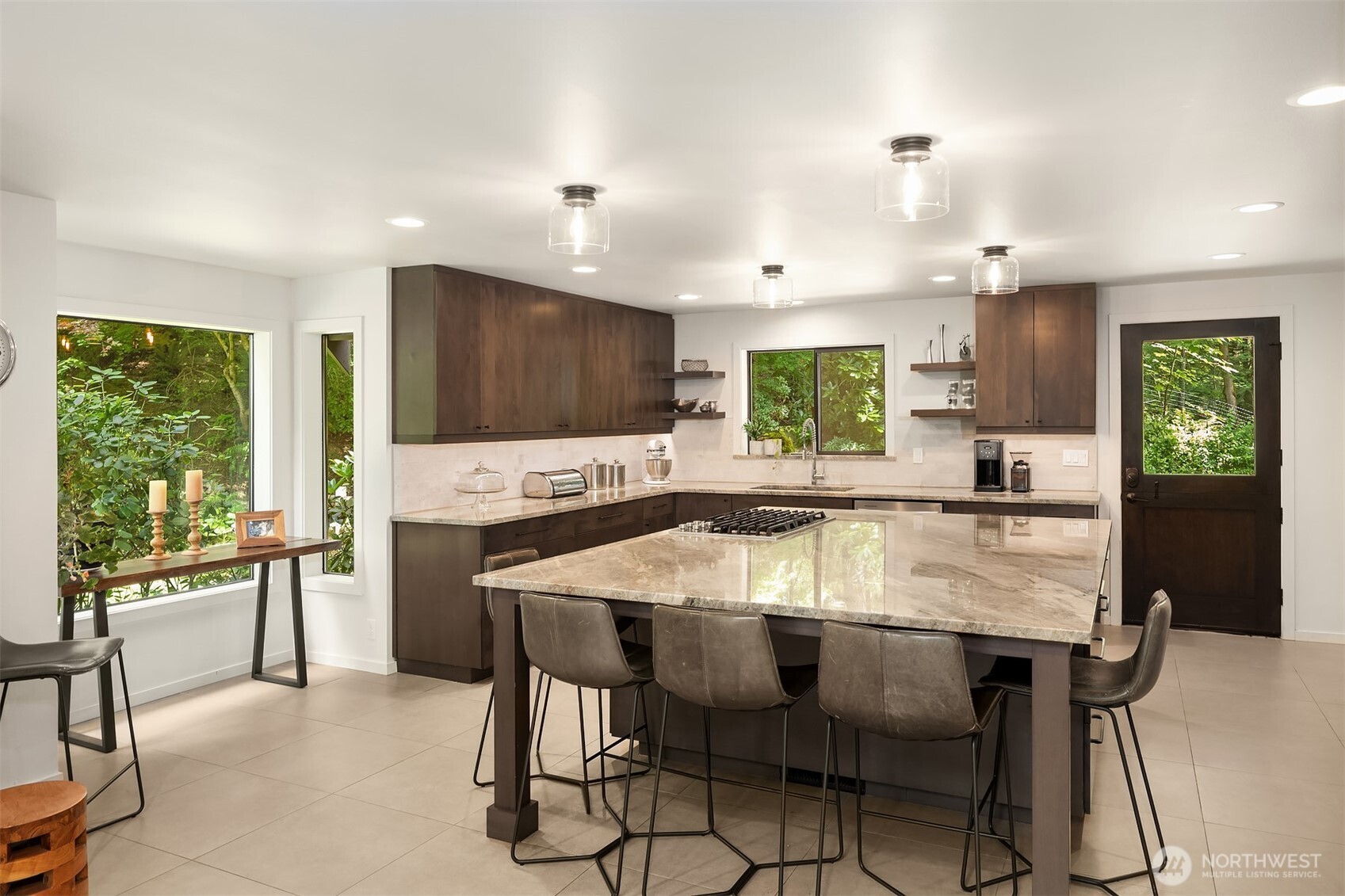 New kitchen remodel with quartzite counters, custom cabinets with under cabinet lighting, and a dream island with ample seating.