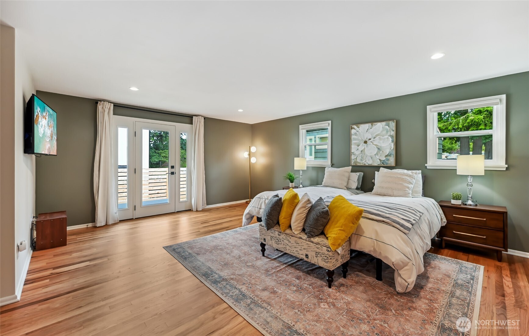 Large and expansive primary suite opens to deck and fully fenced backyard.
